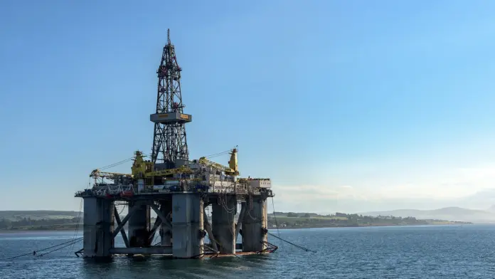 <strong>Updated 22 September 2026, 13:00 UTC</strong>
<strong>Brent crude (November futures): $98.55 a barrel</strong>, down about 1.8% from Monday's settlement of $100.34, after touching $97.44 earlier in the session (Yahoo Finance, ICE futures data). WTI trades near $90.16, down about 2.4%.
<strong>Verdict:</strong> Brent has broken below $100 for the first time since 9 September (The National), and unlike Monday's brief dip it is trading well under the line, not just touching it. The drivers are supply, not demand: Saudi exports are coming back and Iran has put a Hormuz reopening on the table. The move sticks only if tankers actually move; a failed round of diplomacy at the UN puts $105 back in play within days.
Key facts
<strong>On course for a fifth straight loss.</strong> Brent fell 3.7% on Monday to about $100.07 by the late-U.S. session, after briefly trading under $100 (Investing.com), and extended the slide on Tuesday. It settled at $108.75 as recently as 15 September (Yahoo Finance daily data).
<strong>Iran's offer.</strong> Tehran signalled it is willing to reopen the Strait of Hormuz within a week if the United States eases military pressure and lifts its blockade of Iranian ports (The National, 22 September).
<strong>Saudi oil is flowing again.</strong> Saudi Aramco restarted its East-West pipeline at a reduced rate, with Red Sea exports from Yanbu expected to resume, and loaded about 14 million barrels onto seven supertankers in the Gulf on Sunday (The National).
<strong>Satellite data backs the trend.</strong> Saudi crude moving through Hormuz averaged about 2.9 million barrels a day over the six days to 18 September, up from roughly 700,000 in August, according to JPMorgan satellite data cited by The National.
<strong>But the strait is still nearly empty.</strong> Only two commercial vessels transited Hormuz on Monday, against about 125 a day before the conflict (The National). The market is pricing an expected reopening, not an actual one.
Why $100 matters for oil traders
Round numbers are psychological, but $100 has also been a practical dividing line this month. Brent went from about $97.92 on 8 September to $107.63 two sessions later, after the attack on Saudi pipeline infrastructure pushed supply fears back to the front (Yahoo Finance daily data). Everything since has been the market unwinding that spike as Saudi flows recovered - a story we followed through the <a href="https://financefeeds.com/brent-crude-oil-price-102-saudi-east-west-pipeline-restart/">East-West pipeline restart</a> and <a href="https://financefeeds.com/brent-crude-oil-price-101-houthi-riyadh-yanbu-saudi-exports-bull-bear/">Monday's slide to $101</a>.
A settlement below $100 would mean the war premium added on 9-10 September has been fully given back. Monday's dip under the line did not stick. Tuesday's settlement is the test: a close below $100 would be the first since 8 September.
The diplomacy trade at the UN
This week's price action is tied closely to the UN General Assembly in New York. Interactive Brokers strategist José Torres noted that Middle East tensions appear to be cooling, with President Trump seemingly open to meeting Iranian President Masoud Pezeshkian during the gathering (as quoted by Investing.com). Iran's conditional Hormuz offer arrived on top of that.
The conditions are the catch. Iran wants the U.S. blockade of its ports lifted and military pressure eased before it reopens the strait. Both conditions ask Washington to move first. Traders who sold Brent below $100 are betting that a deal, or at least a clear path to one, comes out of New York this week. If talks stall, the two-vessels-a-day reality of the strait will reassert itself quickly.
What is still holding prices up
Even at $98, Brent is far above where forecasters expected it to be once supply normalises. The U.S. Energy Information Administration's September Short-Term Energy Outlook sees Brent averaging around $90 a barrel in the second half of 2026 and falling to about $77 by the second quarter of 2027 as Middle East exports recover and shut-in output restarts. Goldman Sachs kept a $80 fourth-quarter 2026 Brent forecast in July, conditional on U.S.-Iran tensions easing by year-end (Oil & Gas 360).
Fuel markets are the pressure point. U.S. retail diesel is about $6.50 a gallon, the highest this year, and a Rystad Energy economist warned that $100 Brent and diesel at that level are already squeezing consumers (The National). Lower crude would take a while to reach the pump.
Scenarios into late October
Scenario
Level
Anchor
What has to happen
<strong>Bear</strong>
<strong>$90</strong>-8.7% from spot
EIA September STEO: Brent ~$90 average in 2H26
A U.S.-Iran understanding at the UN, Hormuz traffic visibly recovers and Yanbu exports run at full rate.
<strong>Base</strong>
<strong>$100</strong>+1.5% from spot
Monday's settlement near $100.34; the line Brent is testing now
Talks continue without a deal; Saudi flows keep improving but the strait stays mostly shut.
<strong>Bull</strong>
<strong>$108.75</strong>+10.4% from spot
15 September settlement of $108.75
Diplomacy collapses, a new attack hits Gulf infrastructure, or the Saudi pipeline restart stalls.
<strong>Quick Take</strong>
Brent below $100 is the market giving back the entire war premium it added on 9-10 September, driven by returning Saudi exports and Iran's conditional offer to reopen Hormuz. It is a supply story built on expectations: only two ships crossed the strait on Monday. Watch the UN talks and the daily Hormuz transit count. Real traffic makes $90 - the EIA's second-half average - a reasonable target; a breakdown in diplomacy puts $105 to $109 back on the screen fast.
What it means beyond oil
Cheaper crude has been one of the tailwinds behind this week's risk rally, easing inflation worries and Treasury yields. It helped lift crypto too: Bitcoin broke above $85,000 on Monday (see our <a href="https://financefeeds.com/bitcoin-price-85500-50-week-average-short-squeeze-bull-94800-bear-78800/">Bitcoin price analysis</a>). The reverse also holds: a renewed oil spike would be the most direct macro threat to both equities and crypto this week.
Frequently asked questions
What is the Brent crude oil price today?
About $98.55 a barrel for November Brent at 13:00 UTC on 22 September 2026, down roughly 1.8% on the day. It touched $97.44 earlier in the session.
Why is oil falling today?
Saudi Aramco restarted its East-West pipeline and Red Sea exports are resuming, while Iran signalled it could reopen the Strait of Hormuz within a week if the U.S. lifts its port blockade and eases military pressure. Hopes for diplomacy at the UN General Assembly added to the selling.
When was Brent last below $100?
Brent last settled below $100 on 8 September, at $97.92, and traded under it early on 9 September before the attack on Saudi pipeline infrastructure drove it to about $109 the next day (Yahoo Finance daily data). It dipped under $100 briefly on 21 September but settled above it.
Is the Strait of Hormuz open?
Not in practice. Only two commercial vessels transited on 21 September, against about 125 a day before the conflict. Iran's offer to reopen it is conditional on U.S. concessions.
What is the EIA forecast for Brent?
The September Short-Term Energy Outlook projects Brent averaging around $90 a barrel in the second half of 2026, falling to about $77 by the second quarter of 2027.
What is WTI crude trading at?
About $90.16 a barrel at 13:00 UTC on 22 September, down roughly 2.4% on the day.
Could Brent go back above $105?
Yes, if the UN diplomacy fails or Gulf supply is disrupted again. Brent settled at $108.75 as recently as 15 September.
<em>Data sources: Yahoo Finance (ICE Brent and NYMEX WTI futures quotes, 22 September 2026, 13:00 UTC; Brent daily settlements for September), The National (Hormuz offer, Aramco restart, JPMorgan satellite data, vessel transits, diesel price and Rystad comment, 22 September), Investing.com (21 September close and Interactive Brokers comment), U.S. EIA (September 2026 Short-Term Energy Outlook), Oil & Gas 360 (Goldman Sachs forecast, July 2026). Oil futures trade almost around the clock and prices may have moved since publication.</em>
<em><strong>Disclaimer:</strong> This article is for informational purposes only and does not constitute financial, investment or trading advice. Commodity futures are highly volatile and leveraged, and you may lose some or all of your capital. Price scenarios are illustrative and not forecasts. Always conduct your own research and consider consulting a licensed financial adviser before making investment decisions.</em>